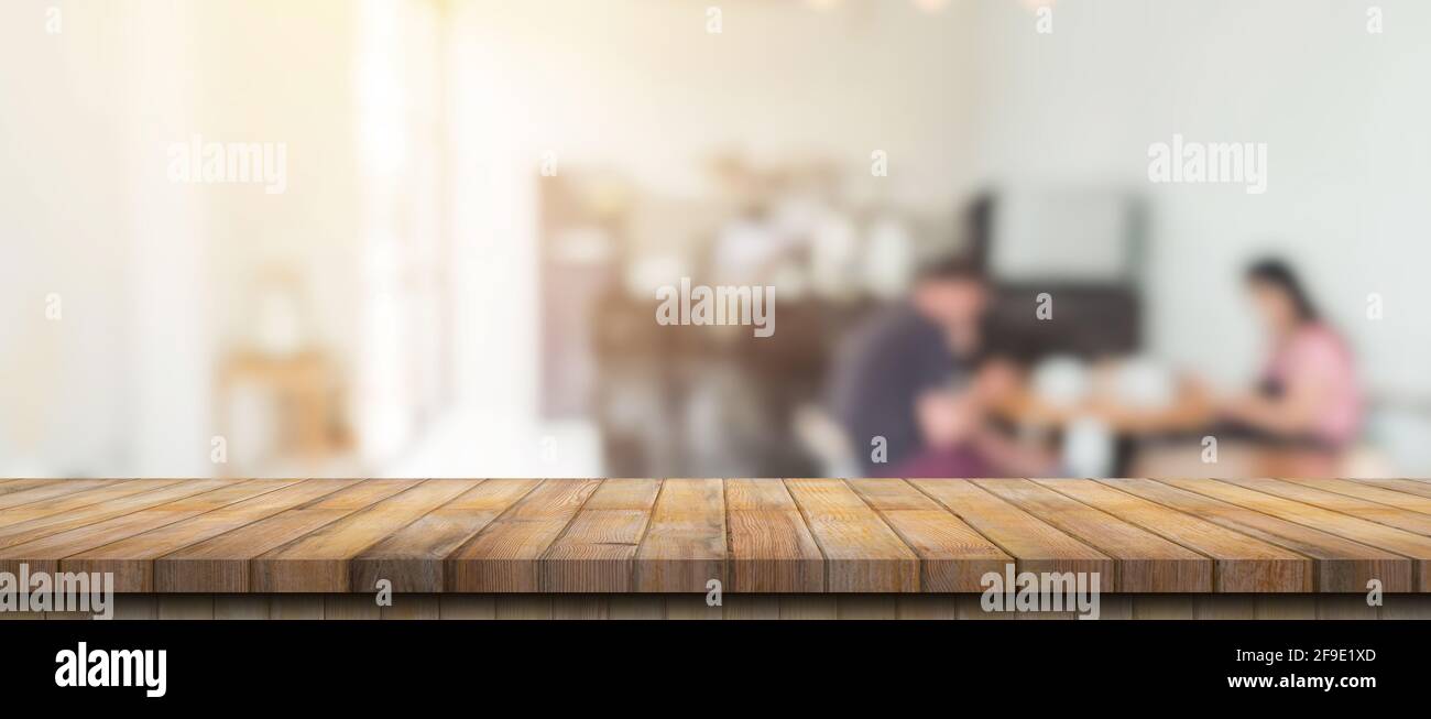 Empty wood table and blurred light table in coffee shop and cafe with ...