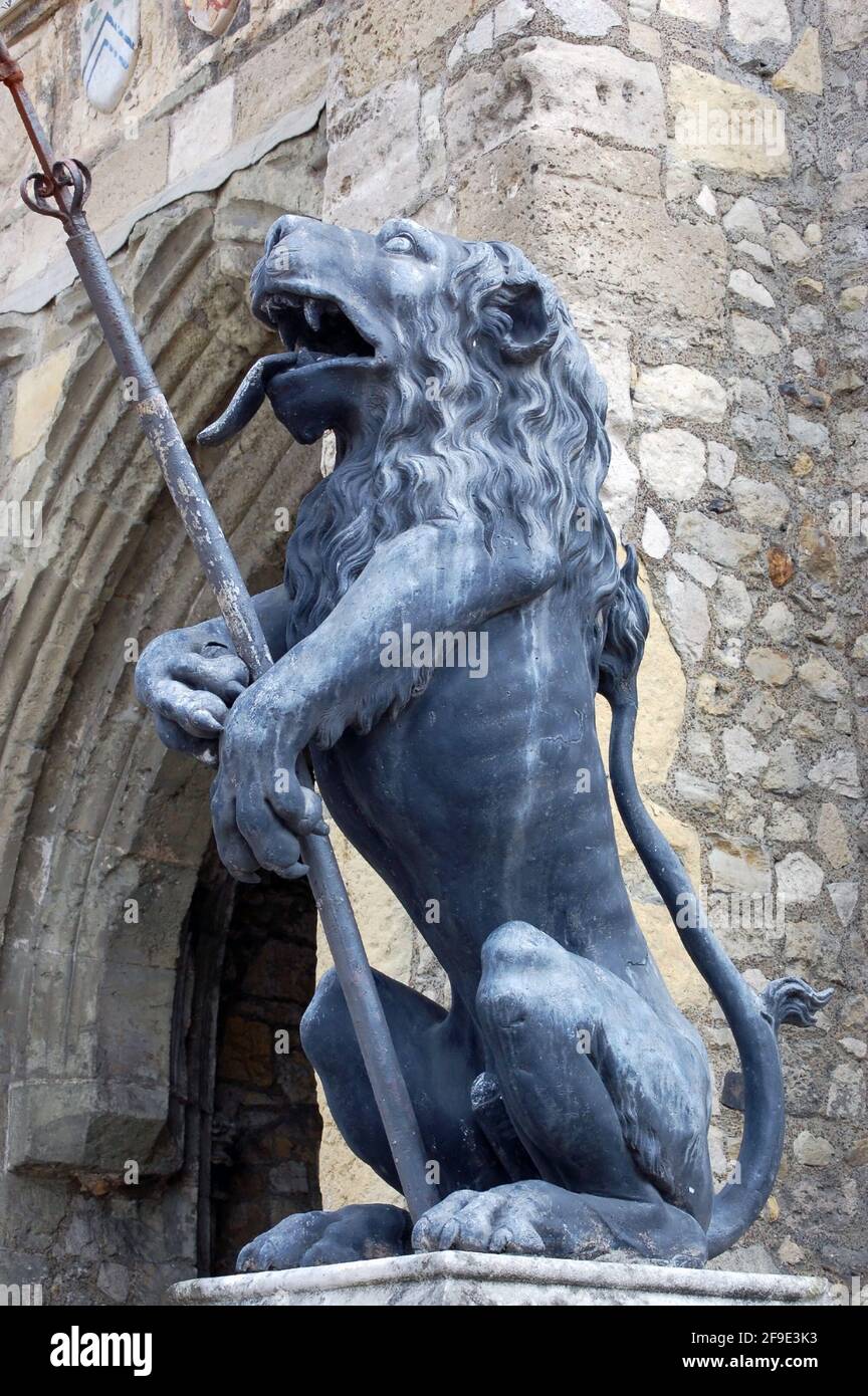 Bronze lion holding a spear on the side of the landmark Bargate in the middle of Southampton City Centre in Hampshire. Stock Photo