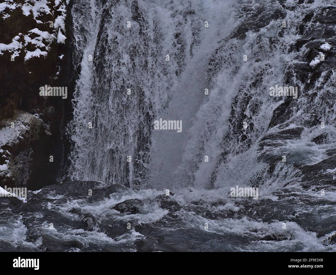 Close-up view of cascade of Skógá river in rocky gorge with water falling down a deep slope in the south of Iceland near ring road. Stock Photo