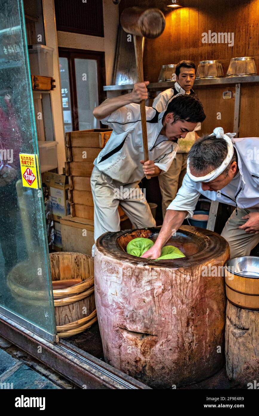 Bakers battering dough for cooking cakes in the street, Nara, Japan. Stock Photo