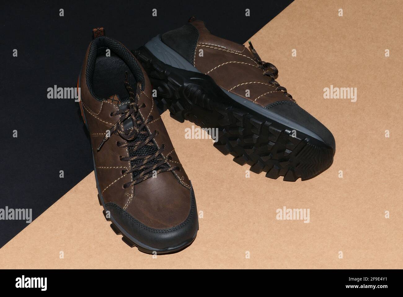 Men's shoes are stylish brown on a black-grey background. Stock Photo
