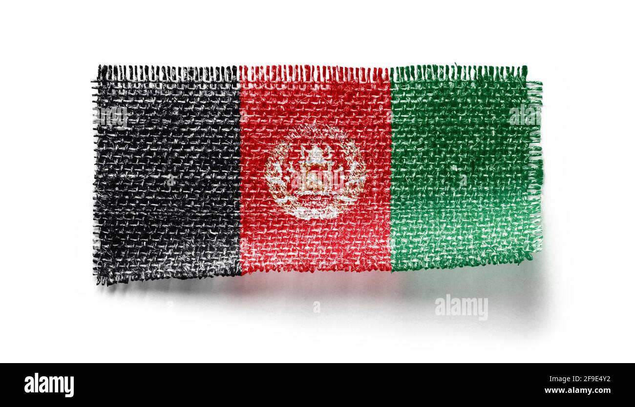 Afghanistan flag on a piece of cloth on a white background Stock Photo