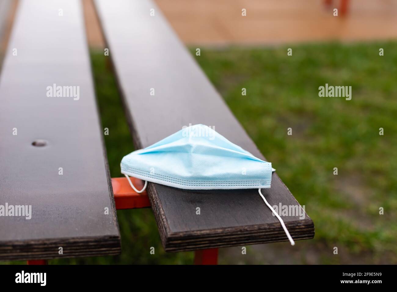 medical mask lies on a bench in the park Stock Photo - Alamy