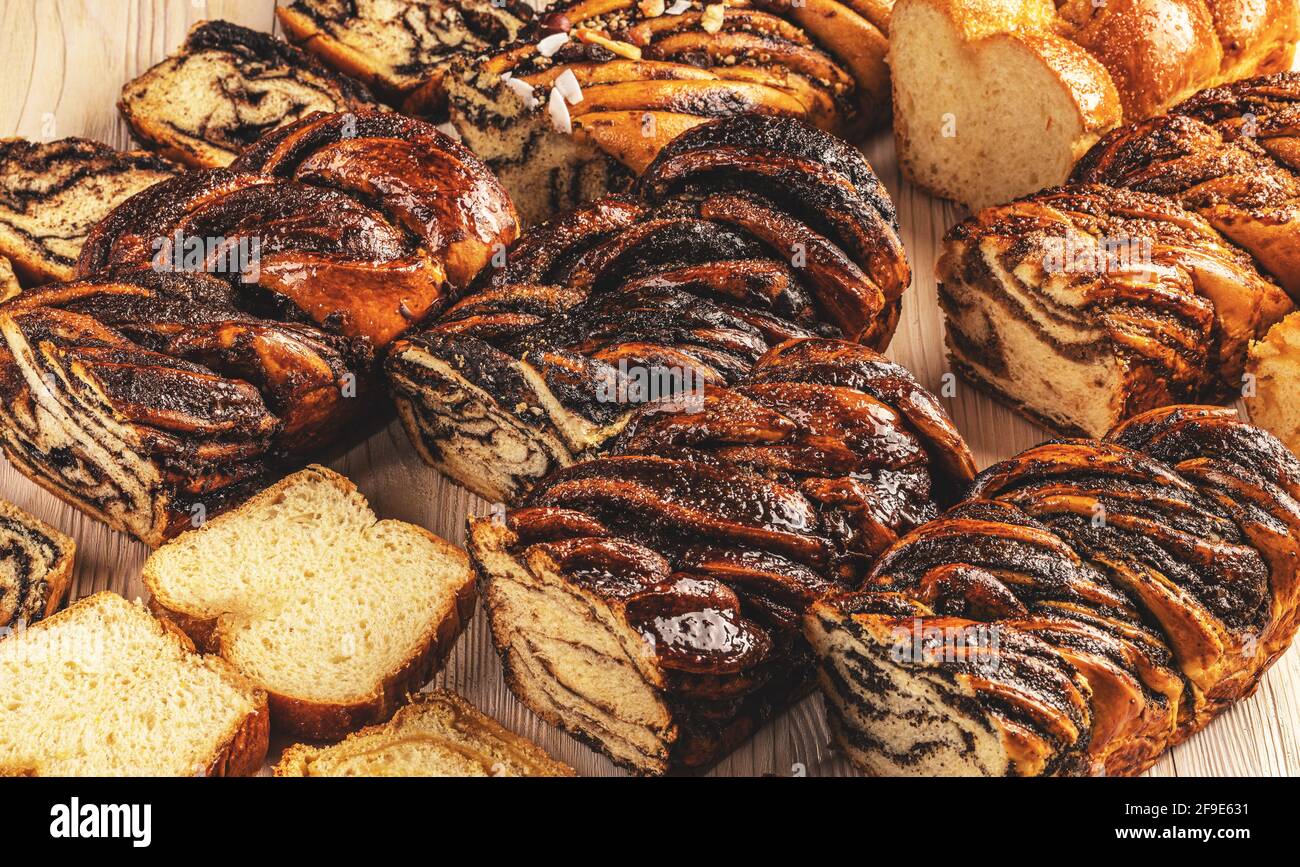 Various type of babka or brioche bread. Stuffed with chocolate, poppy seeds, walnuts Stock Photo