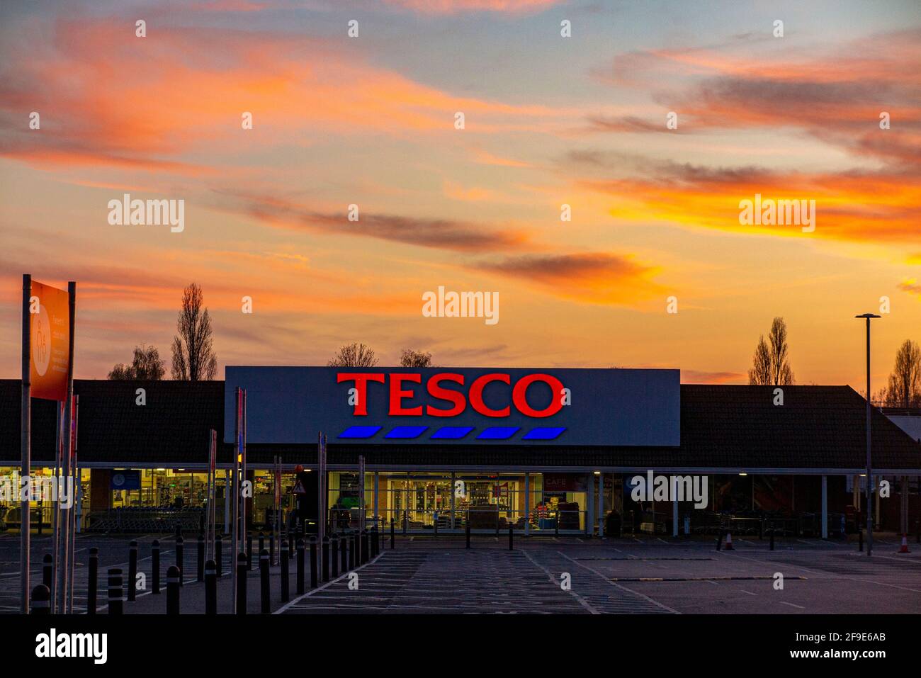 A large Tesco branch in West Sutton, empty during coronavirus lockdown with a draatic sunset behind it Stock Photo