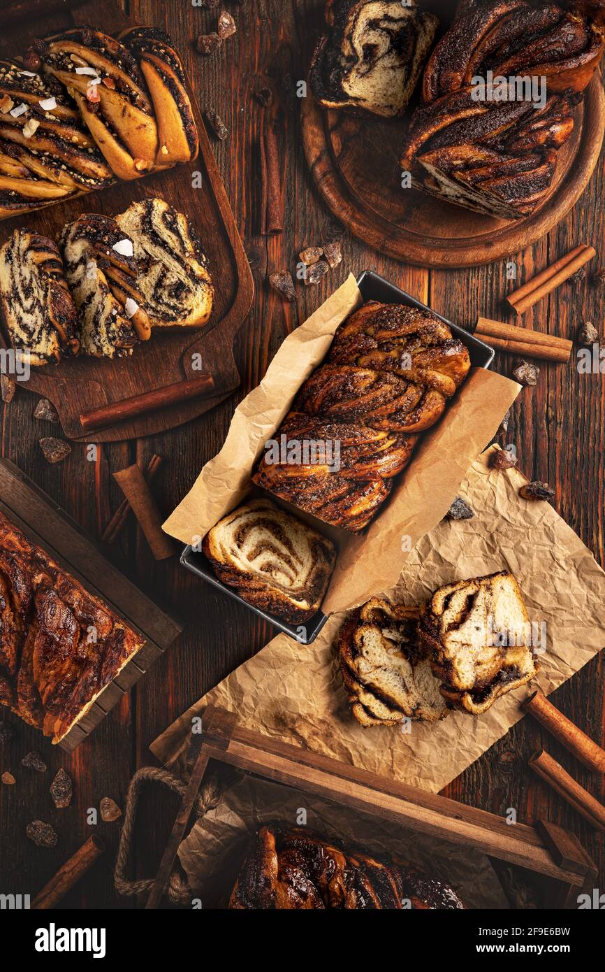 Still life of different type of babka or sweet brioche bread on dark wooden background Stock Photo