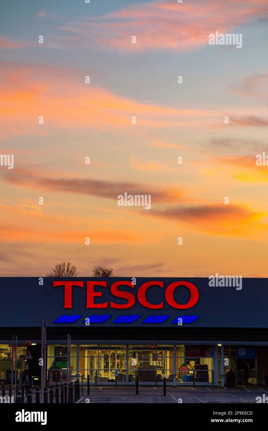 A large Tesco branch in West Sutton, empty during coronavirus lockdown with a draatic sunset behind it Stock Photo