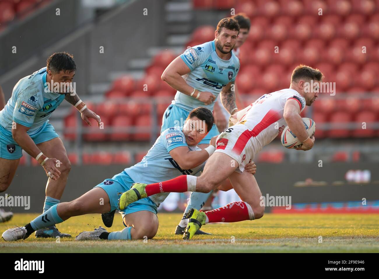 St Helens vs Wakefield Trinity, R3 Super League, 16th April 2021.  St. Helens's Tom Makinson is tackled by  Wakefield Trinity's Mason Lino Stock Photo