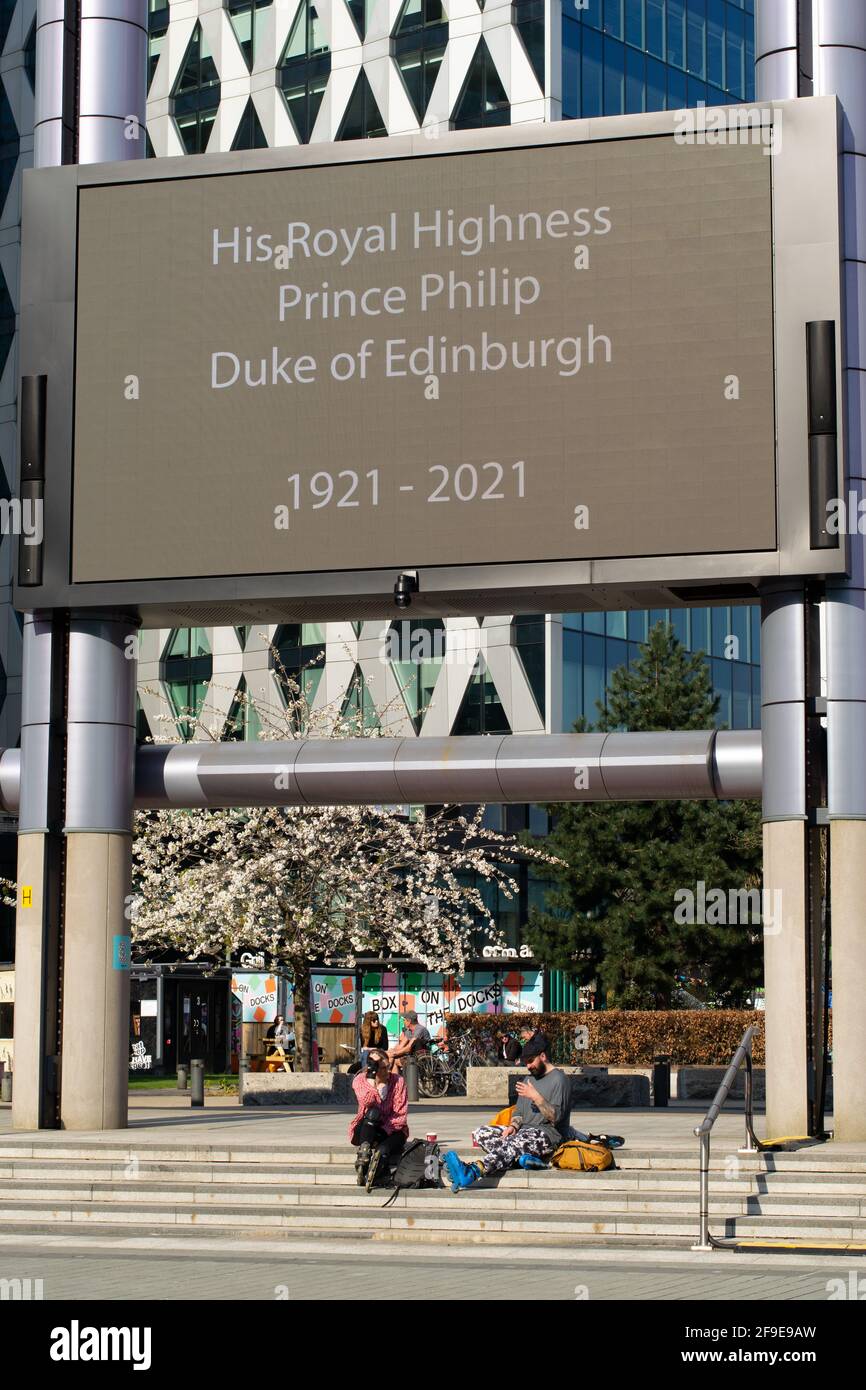 Duke of Edinburgh BBC display on the day of the funeral at Media City, Salford Quays. People sat on steps as national lockdown restrictions ease. Stock Photo