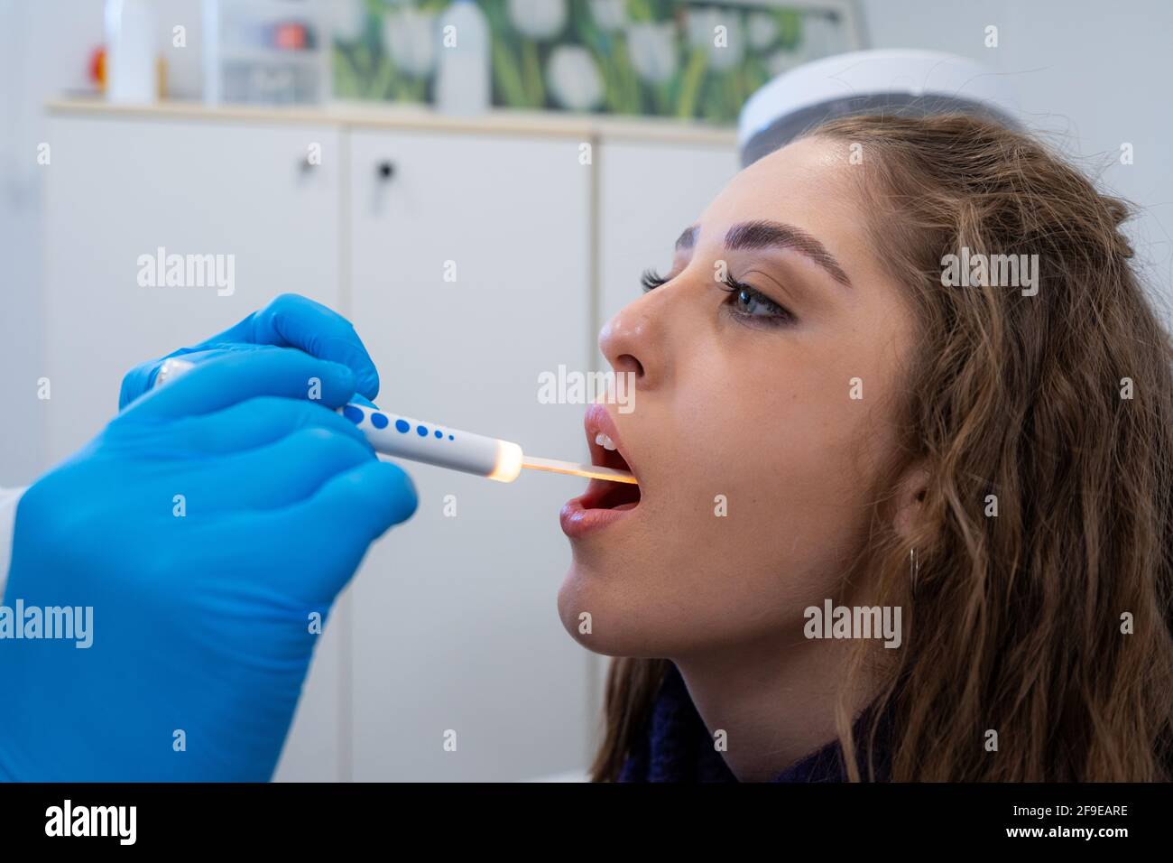 Side view of cropped unrecognizable otolaryngologist in latex gloves ...