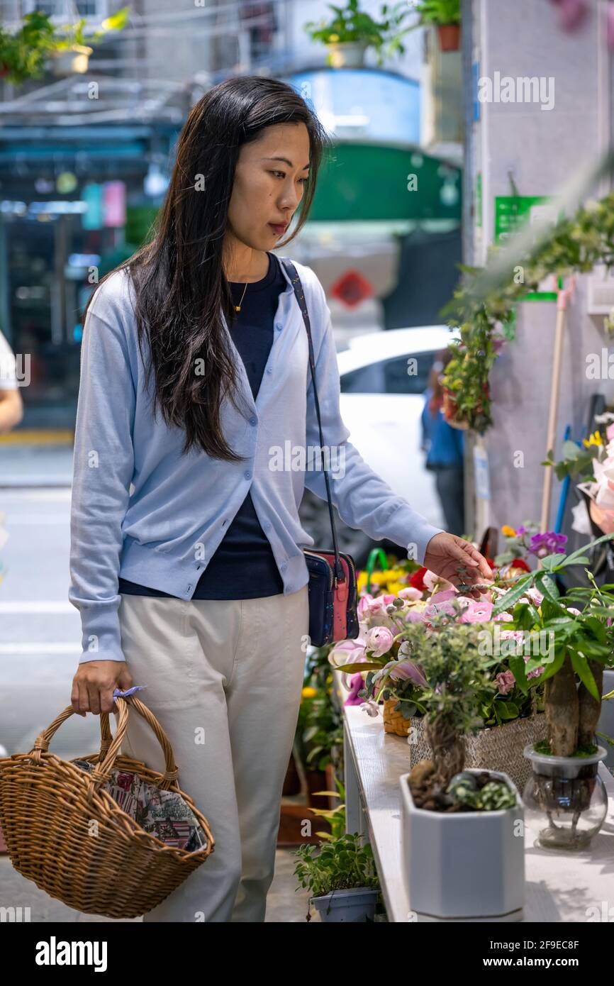 Beautiful Asian girl buying flowers in flower shop Stock Photo Alamy