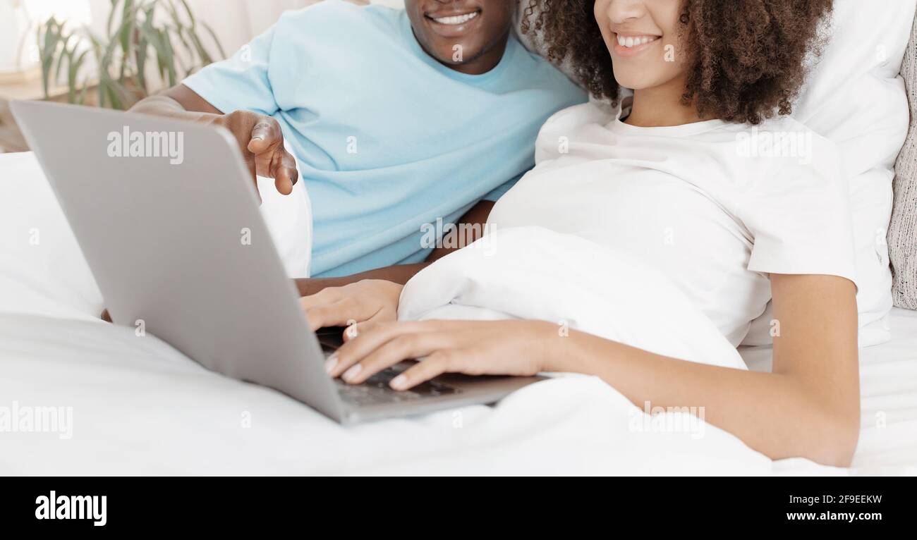 Shopping at home together, surfing in internet, online meeting and funny video Stock Photo