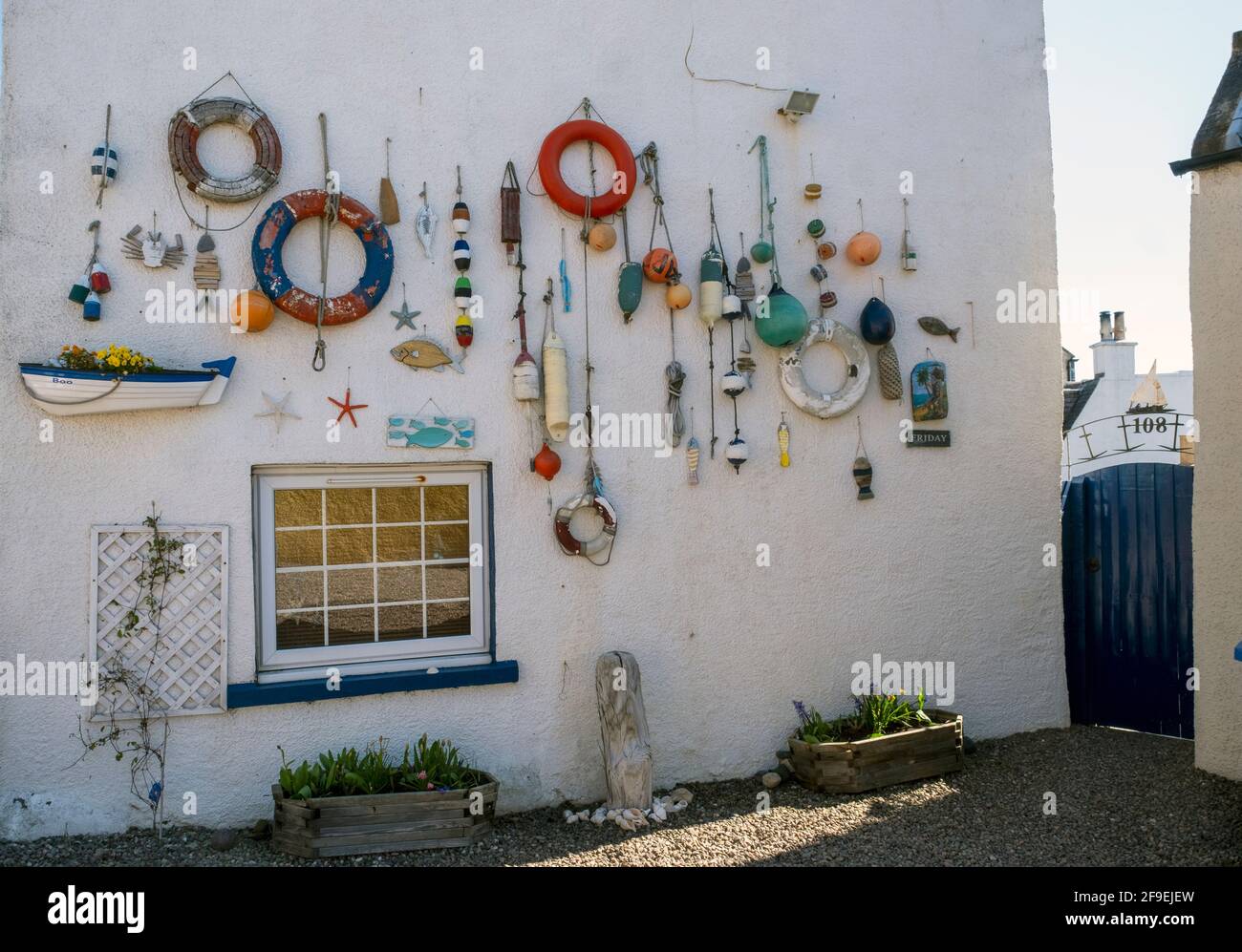 The wall of a house in Lower Largo, Fife decorated with a fishing theme. Stock Photo