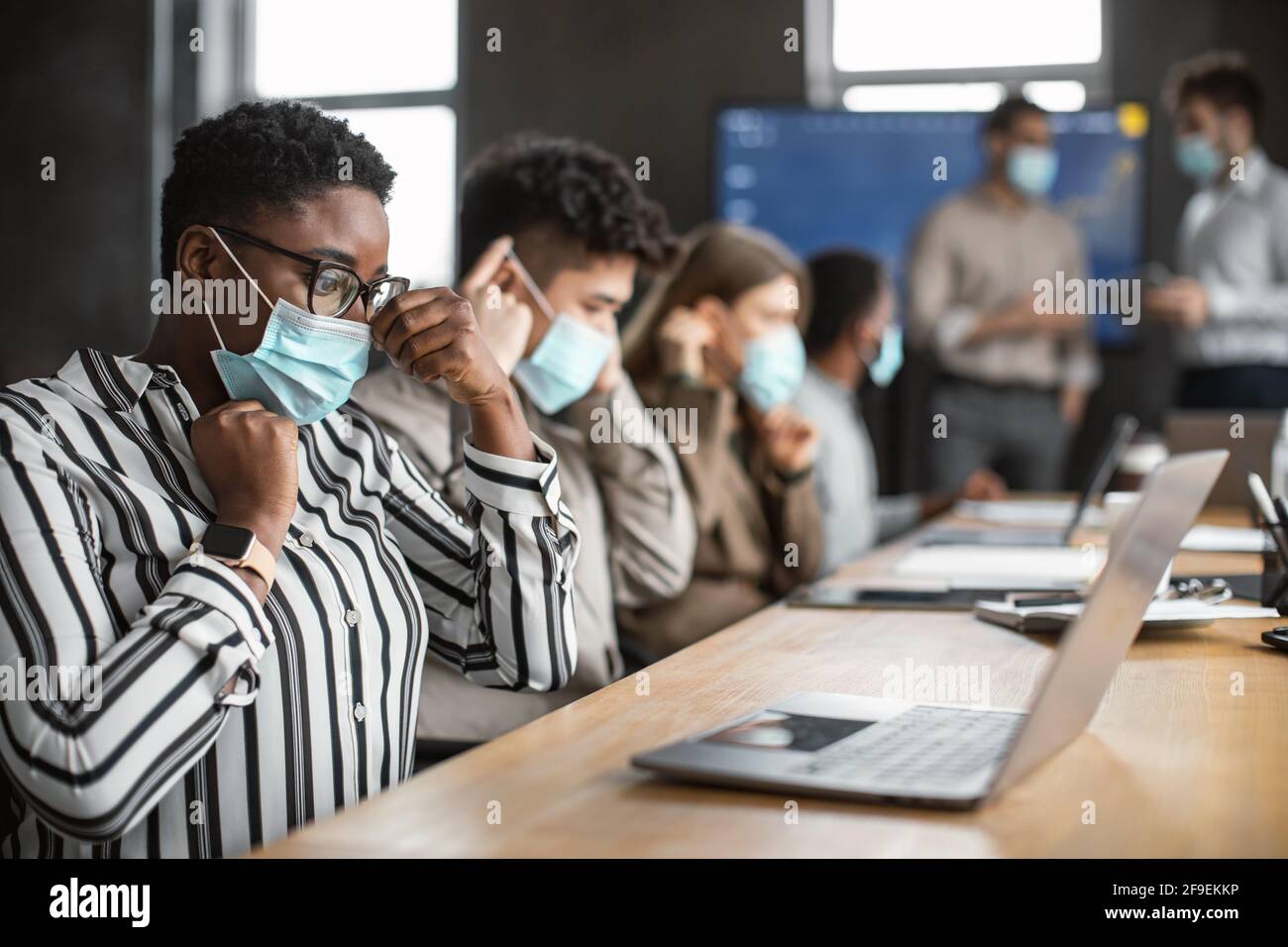 International people wearing medical masks using laptop Stock Photo - Alamy