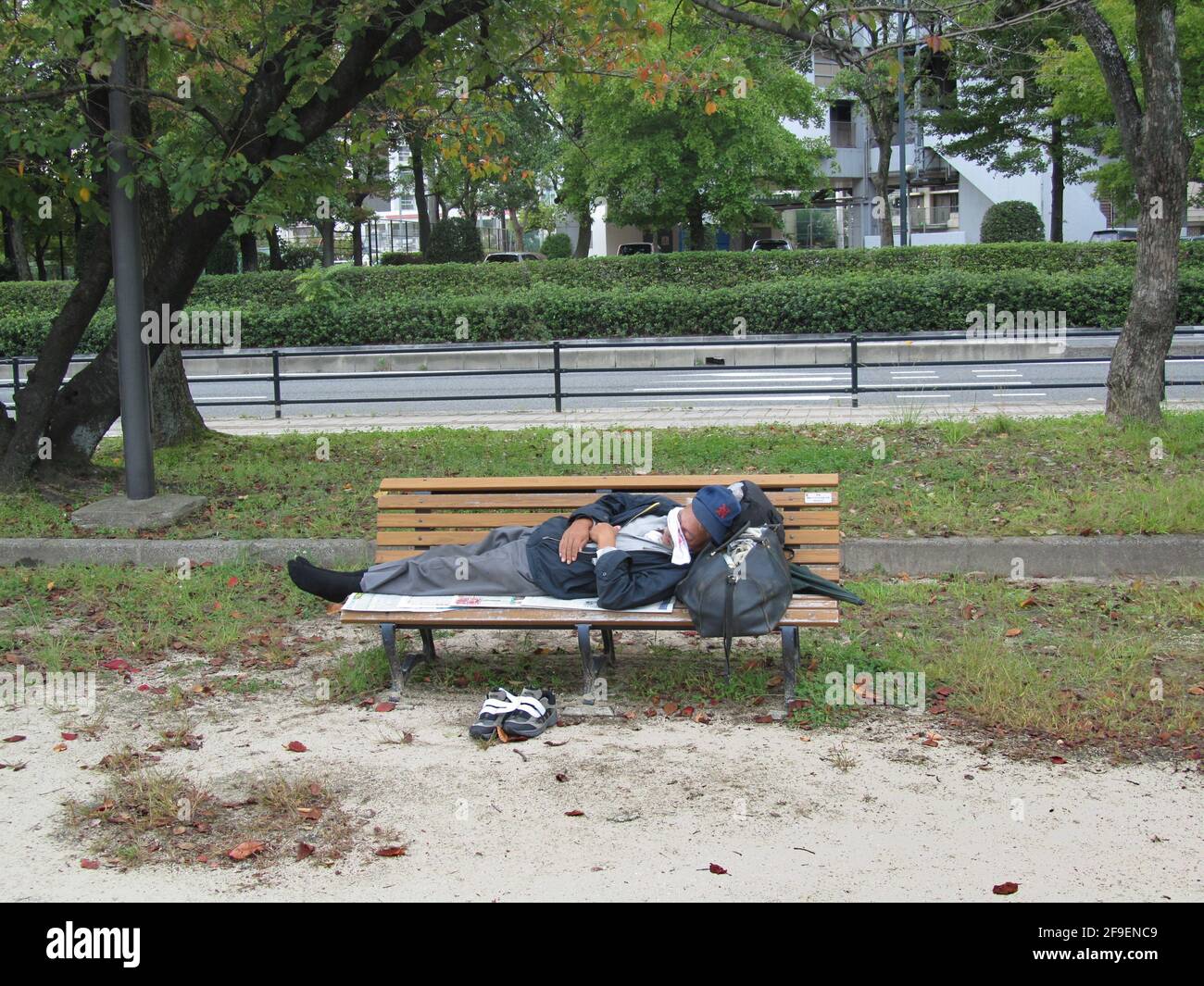 sleeping man on a bench in Hiroshima Stock Photo Alamy