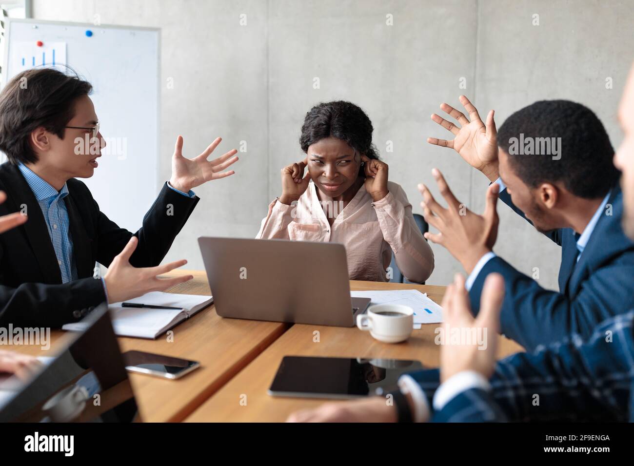 Angry Colleagues Shouting At Female Manager During Meeting In Office Stock Photo