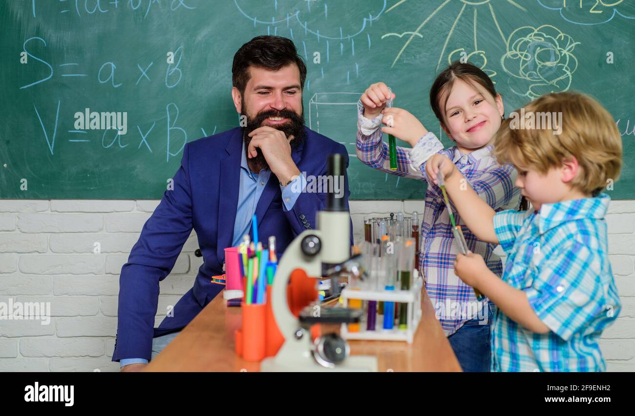 happy children teacher. back to school. biology education. Microscope. Biology school laboratory equipment. experimenting with chemicals or microscope Stock Photo