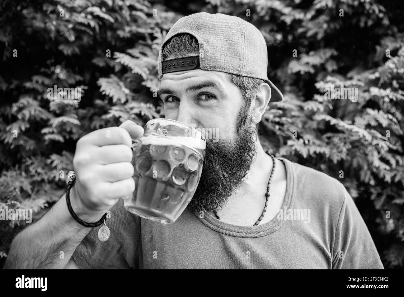 Im only here for drinking beer. Bearded man drinking alcohol on nature