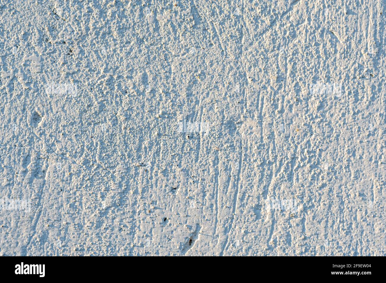 A closeup shot of a textured white wall for wallpaper and background ...