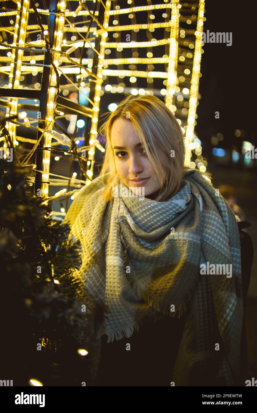 An attractive confident Bosnian girl on the street surrounded by christmas  lights in the evening Stock Photo - Alamy
