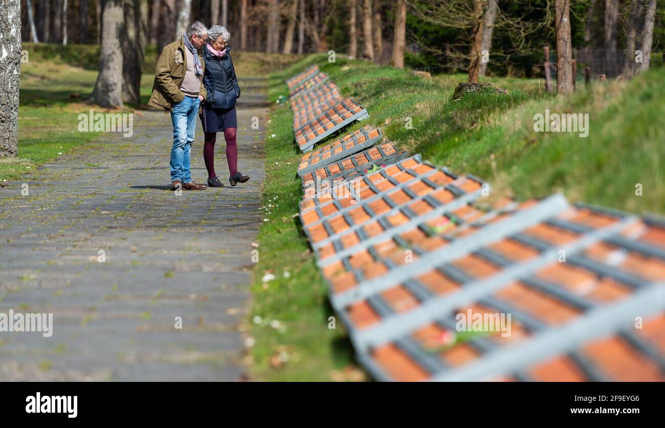 18 April 2021, Lower Saxony, Lohheide/Hörsten: Two visitors from Hanover walk through the Soviet POW cemetery near Bergen-Belsen. The Association of Persecuted Nazis and the German Trade Union Confederation (DGB) commemorated the anniversary of the liberation of the Bergen-Belsen concentration camp. Photo: Philipp Schulze/dpa Stock Photo
