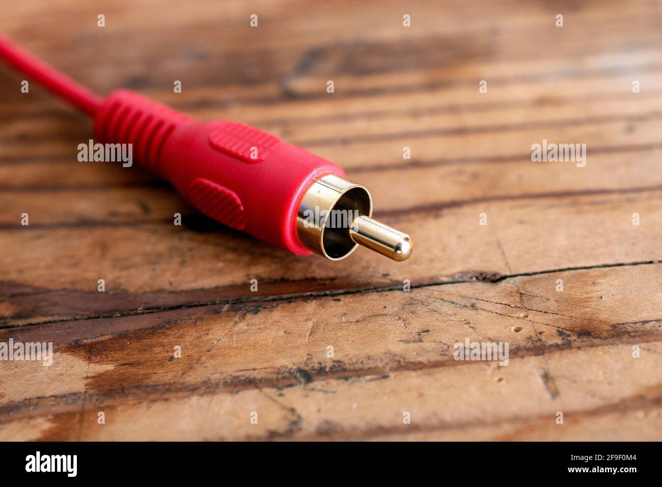audio-video analog cable on an old wood table background. Stock Photo