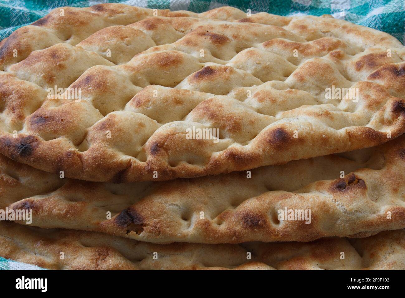Three Ramadan pitas. (Turkish name is Ramazan Pidesi.) Traditional Turkish bread consumed only during Ramadan. Stock Photo