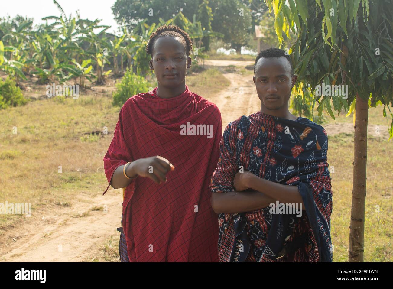 Dodoma, Tanzania. 08-18-2019. Portrait of two black young male farmers, from maasai ethnic group, working as security for a local school in Tanzania. Stock Photo