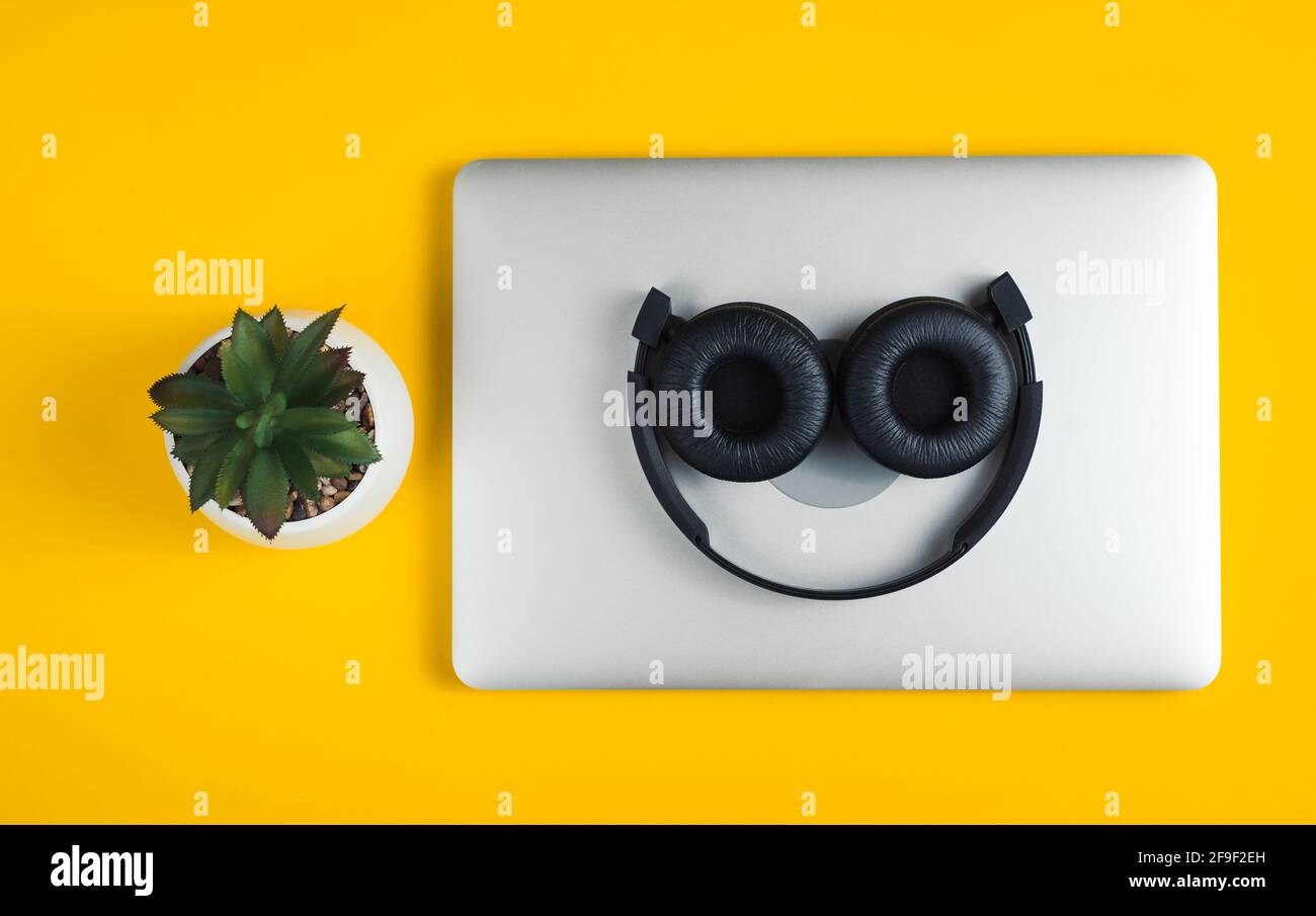 Headphones lie on notebook. Stock Photo