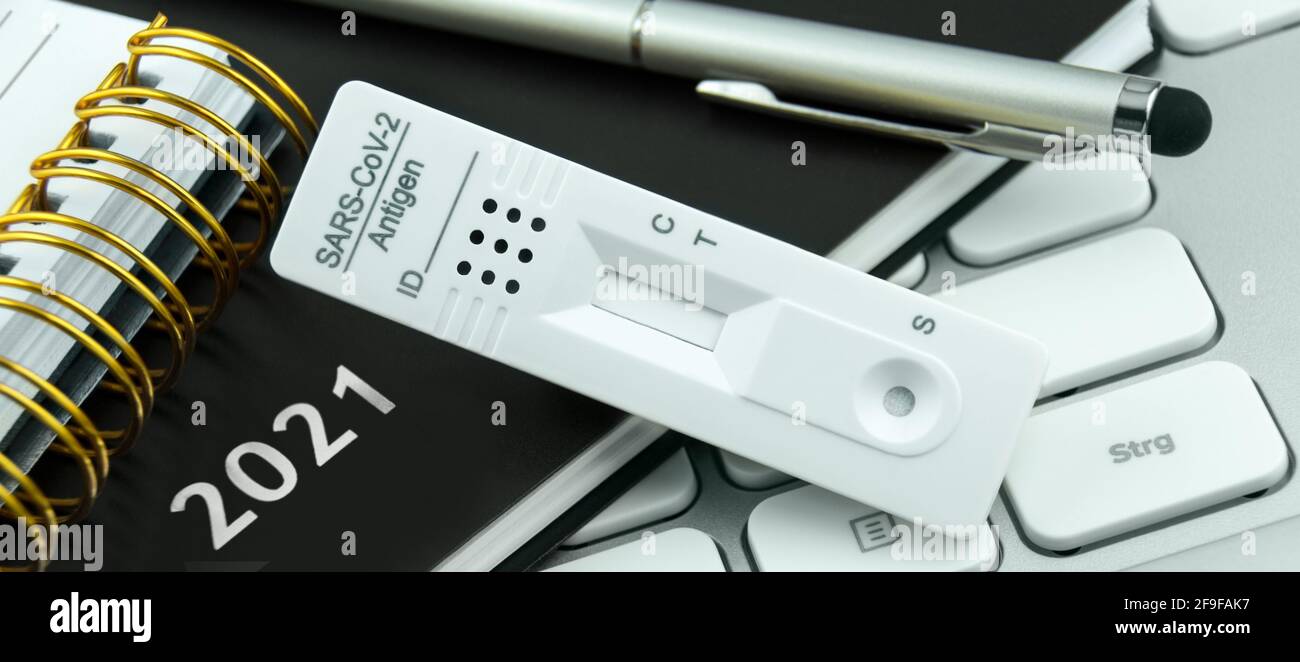 Corona Antigen Rapid Test and PC with calendar 2021 Stock Photo