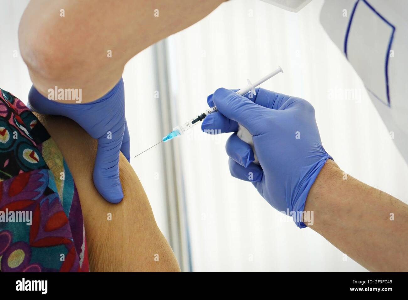 Vaccination Against Covid-19, a person receives coronavirus vaccine. Selective focus on the needle Stock Photo