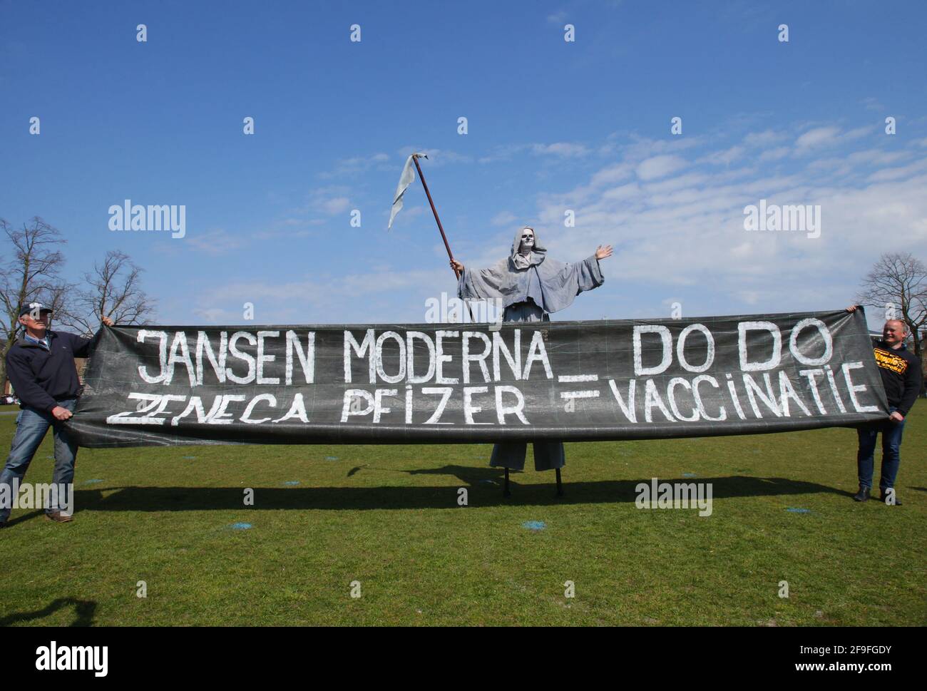 Anti-lockdown protester dressed as the grim reaper stand near a banner with sign coronavirus anti-vaccination during an illegal demonstration against coronavirus measures at the Muaeumplein on April 18, 2021 in Amsterdam,Netherlands. (Photo by Paulo Amorim/Sipa USA) Stock Photo