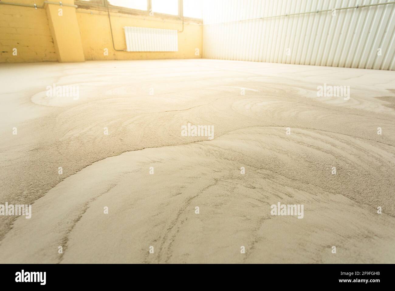 Concrete floor grinding. Construction process. Sanding a concrete floor