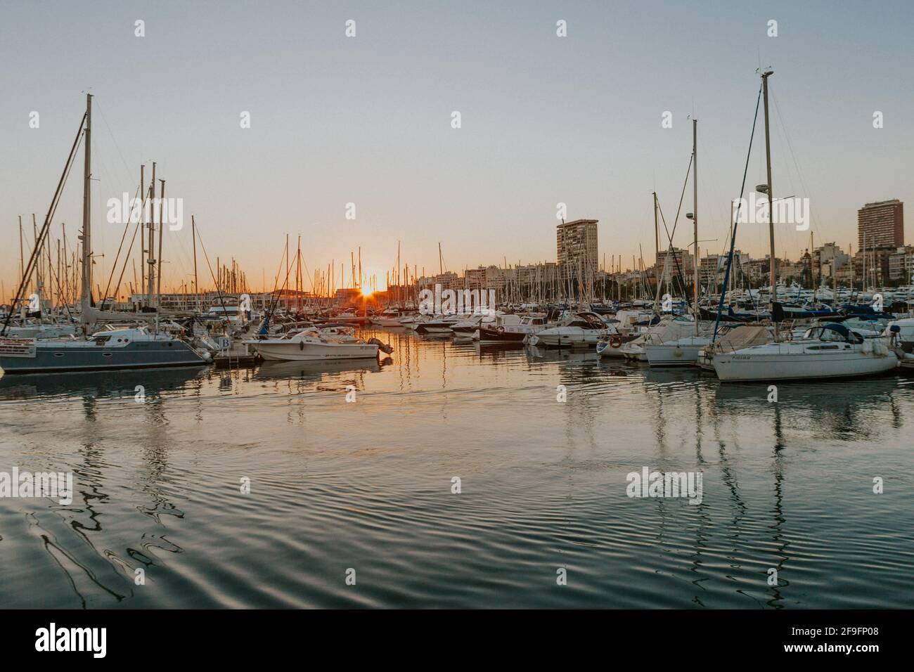 The sailing ships on the port of Alicante during the sunset in the ...