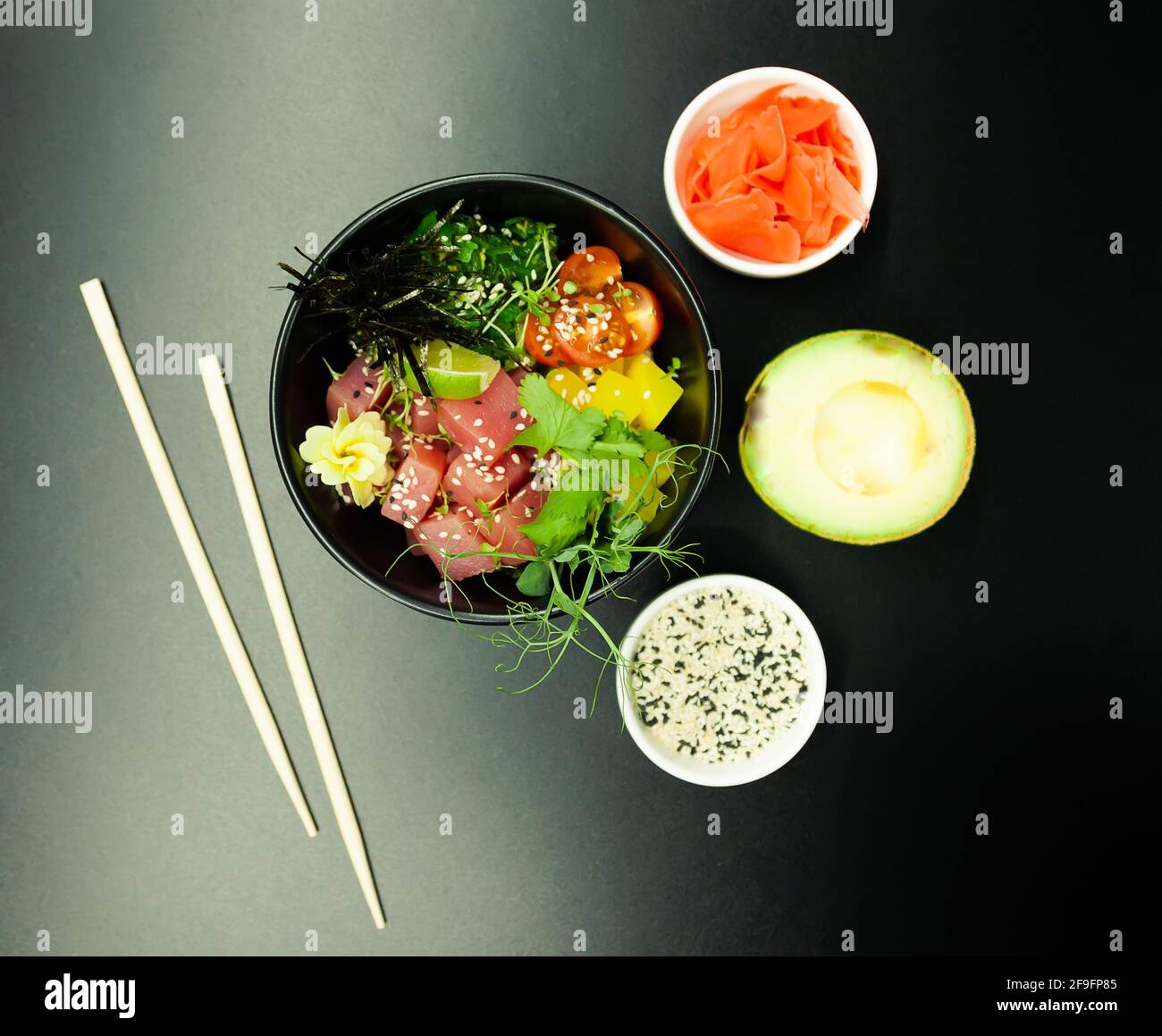 Poke salad with tuna in a bowl. Ingredients fresh tuna, cherry tomatoes