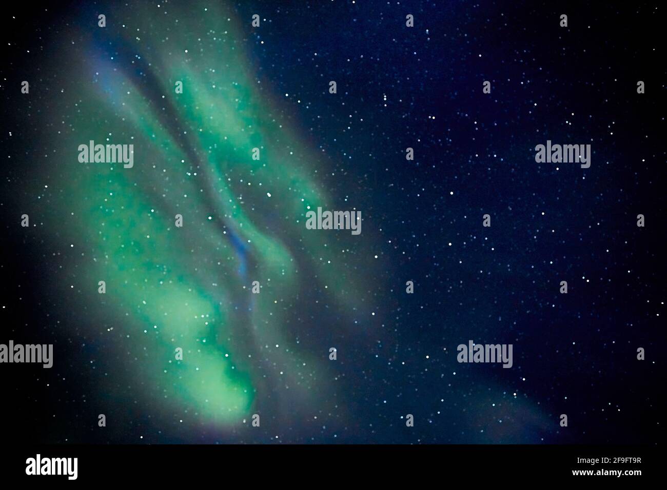 The Northern Lights (Aurora borealis) over Swedish Lapland. The display has the rarely-seen cobalt blue along with the greens and purples Stock Photo