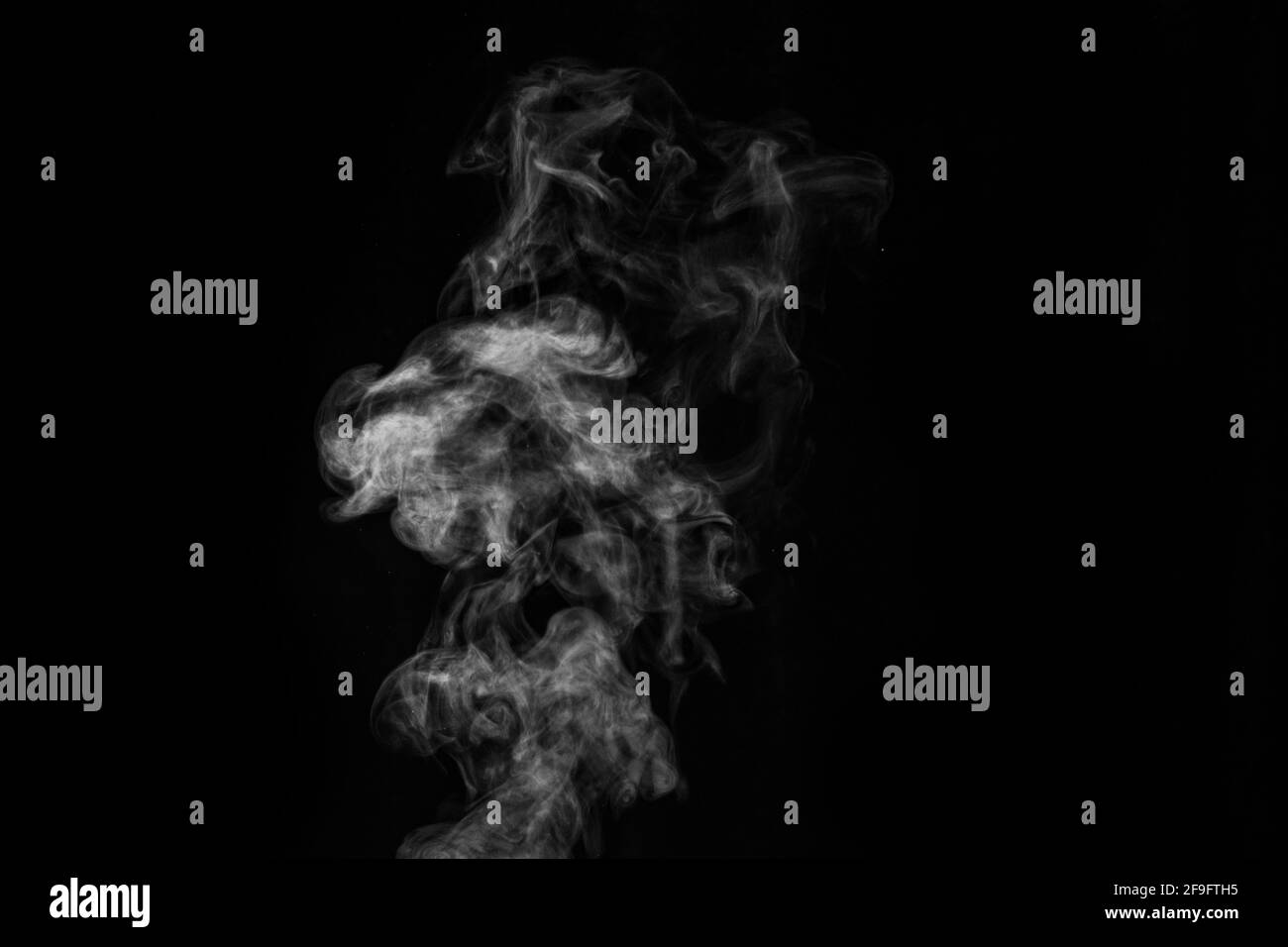 Smoke fragments on a black background. Abstract background, design element, for overlay on pictures. Stock Photo