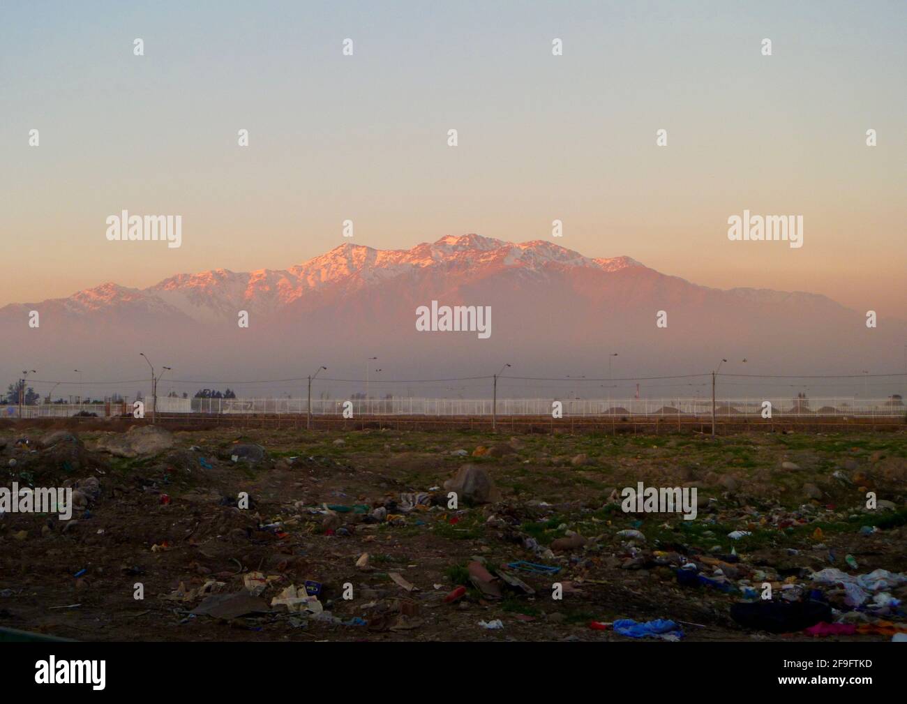 The beautiful Andes juxtapose with a field of Santiago trash Stock Photo