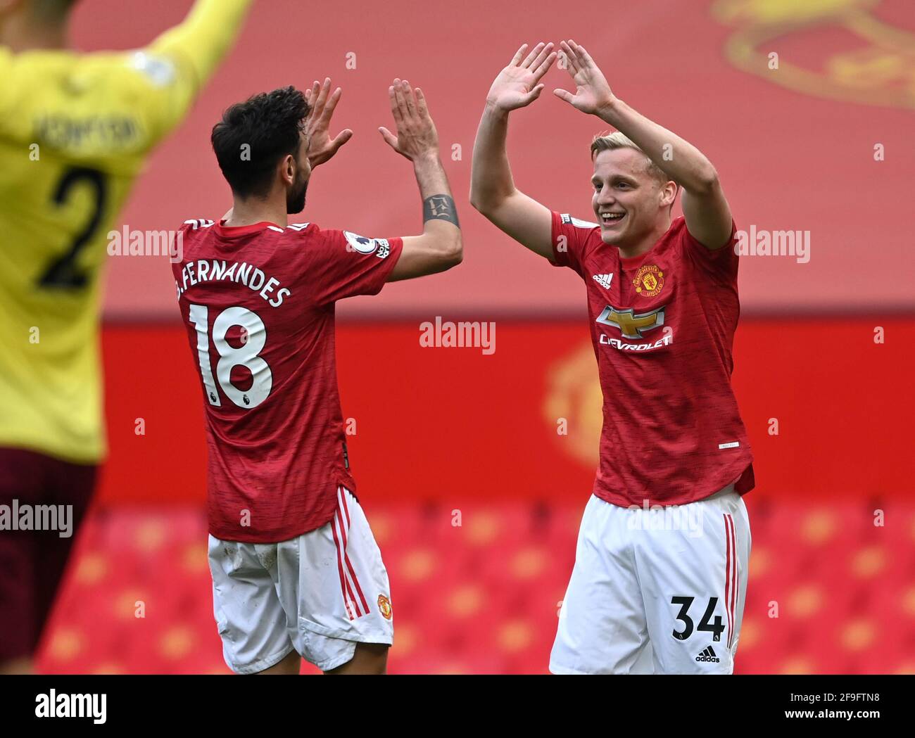 Manchester United's Bruno Fernandes and Donny van de Beek celebrate their side's third goal of the game, scored by Edinson Cavani (not pictured) during the Premier League match at Old Trafford, Manchester. Picture date: Sunday April 18, 2021. Stock Photo