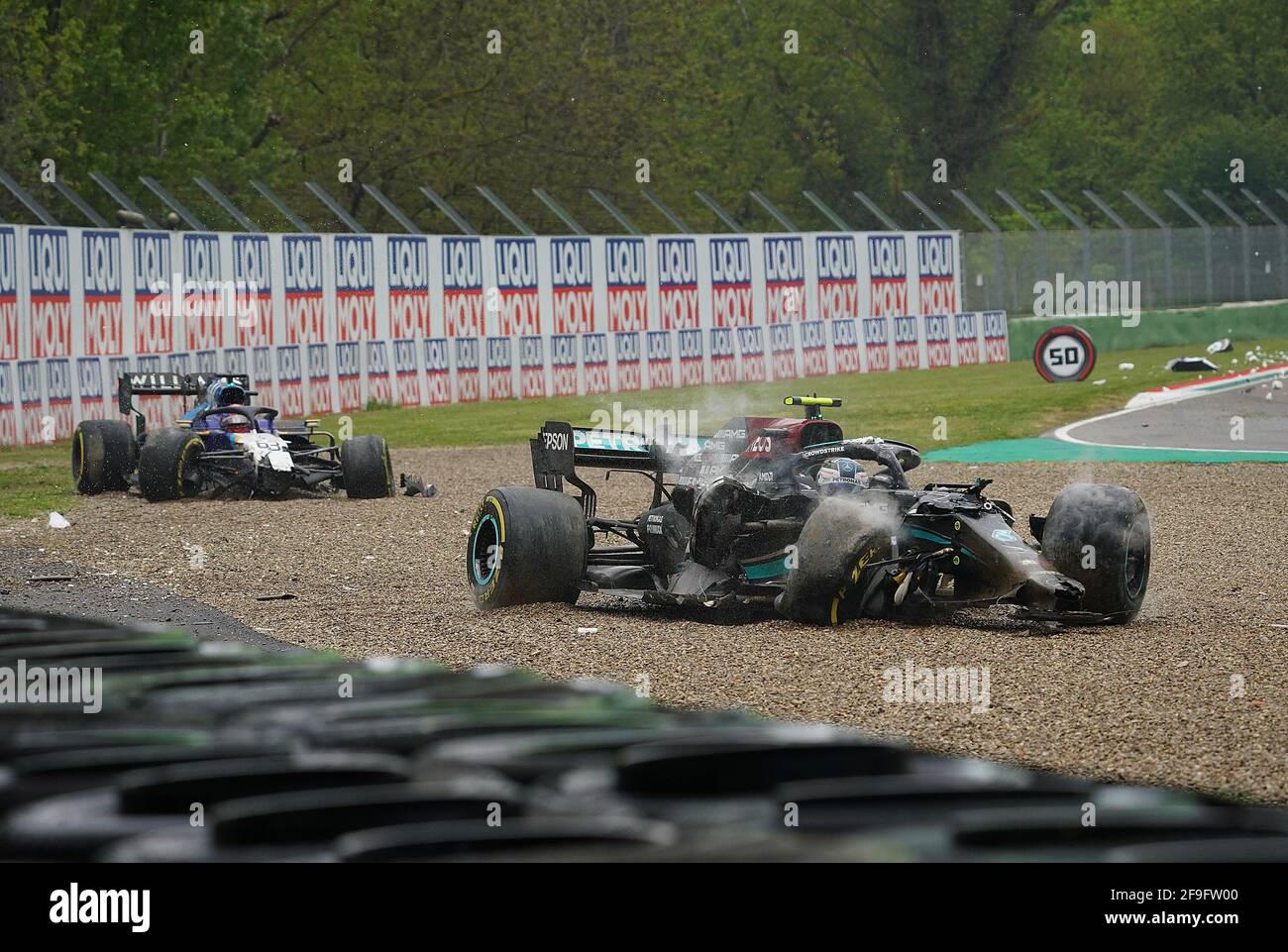 Imola, Italy. 18th Apr, 2021. Motorsport: Formula 1 World Championship, Emilia-Romagna Grand Prix, race. Valtteri Bottas from Finland of the Mercedes-AMG Petronas F1 Team (r) and George Russell from Great Britain of Team Williams Racing (l) are still sitting in their destroyed cars after the accident. Both were able to get out of their cars on their own. Credit: Hasan Bratic/dpa/Alamy Live News Stock Photo
