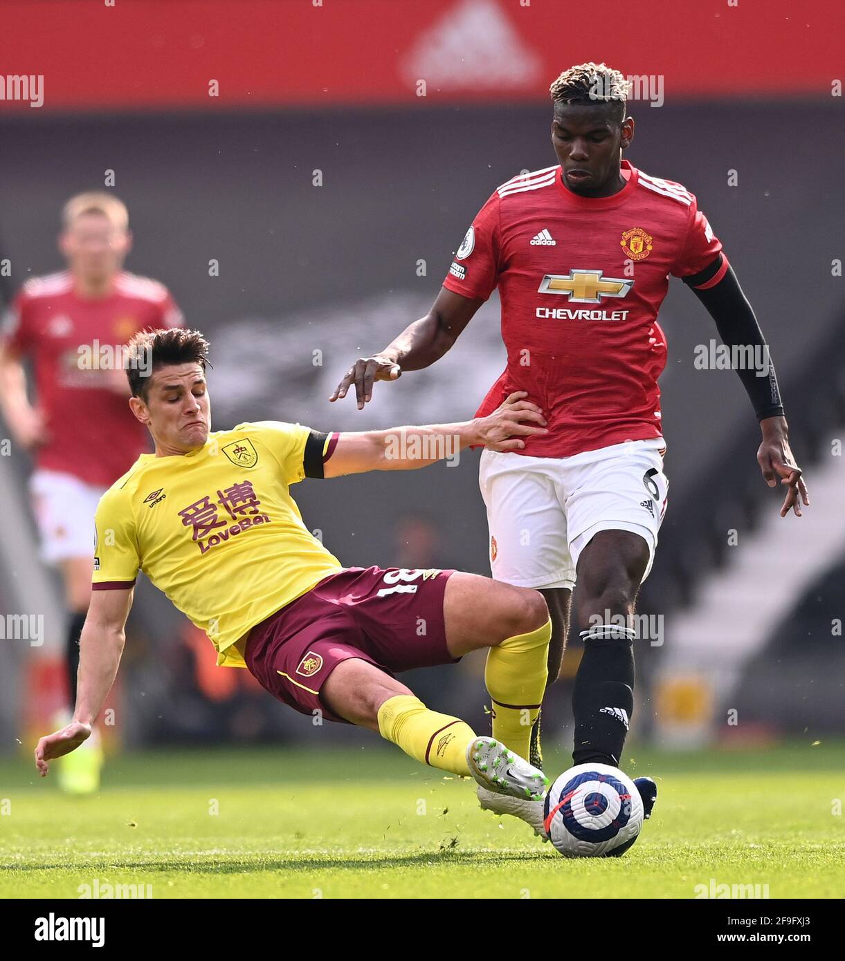 Burnley's Ashley Westwood (left) and Manchester United's Paul Pogba battle for the ball during the Premier League match at Old Trafford, Manchester. Picture date: Sunday April 18, 2021. Stock Photo