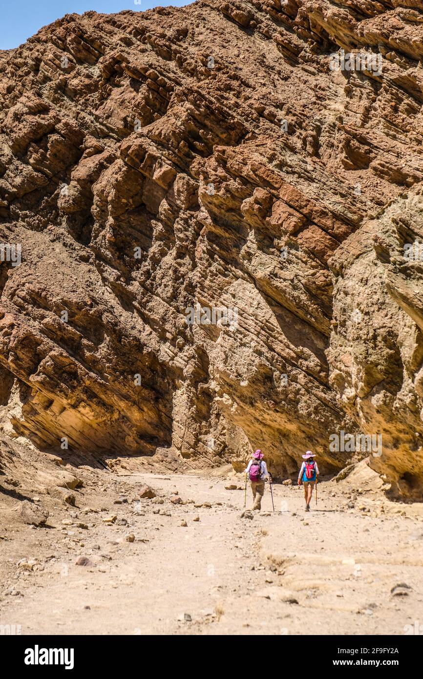 Two Female Hikers Hike Through Golden Canyon In Death Valley National ...