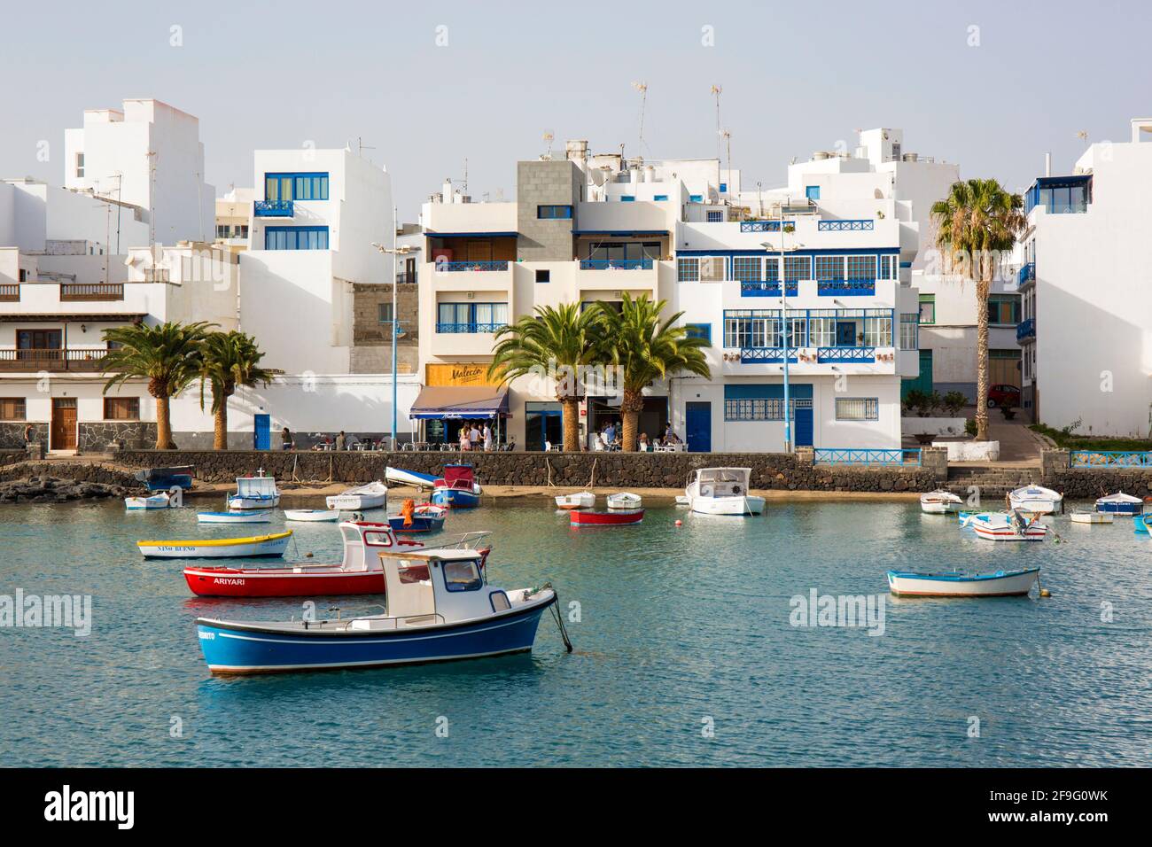 Arrecife, Lanzarote, Canary Islands, Spain. Colourful boats at anchor in the tranquil waters of the Charco de San Ginés. Stock Photo