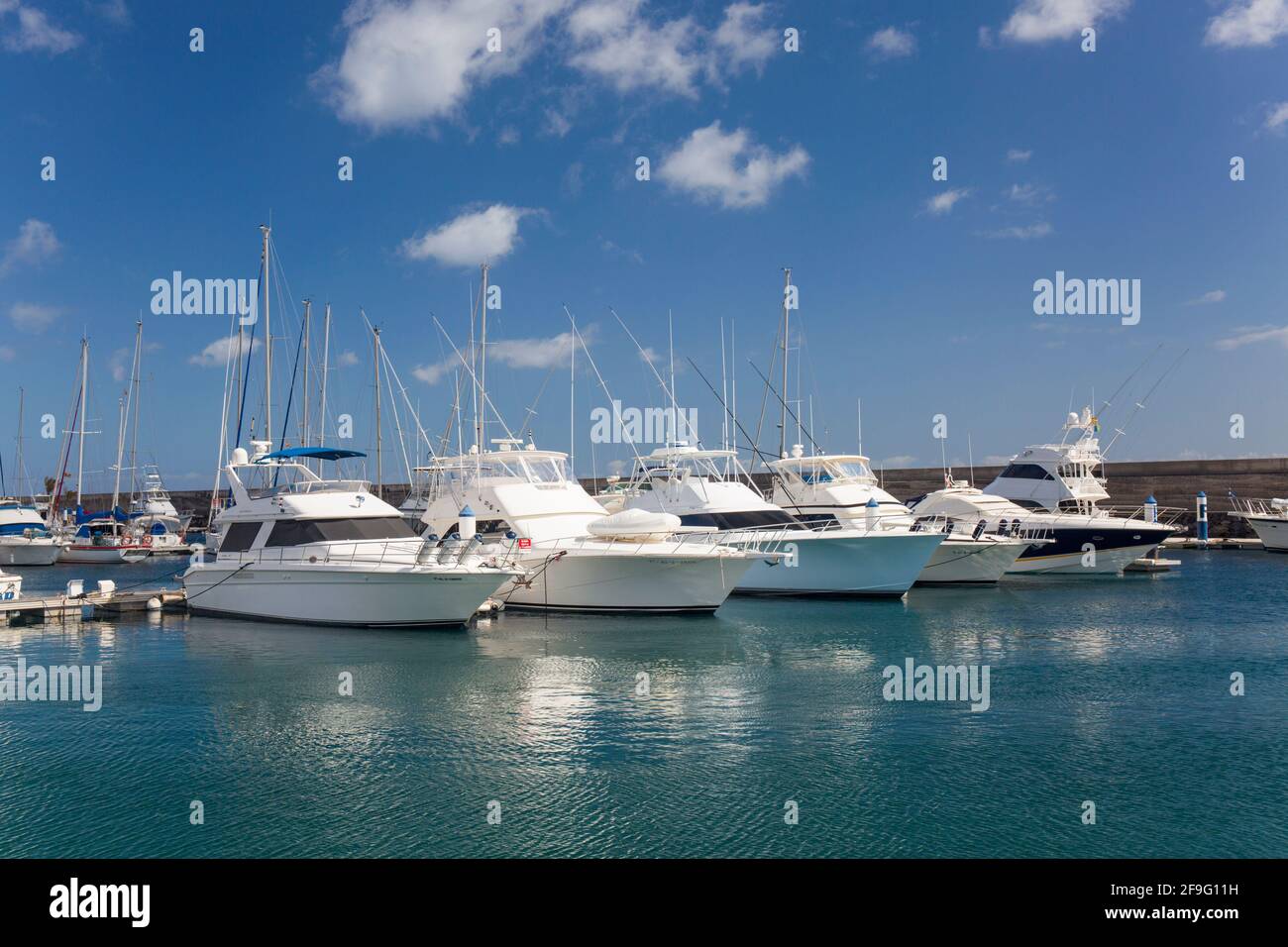 Puerto del Carmen, Lanzarote, Canary Islands, Spain. Motor yachts moored in the marina at Puerto Calero. Stock Photo
