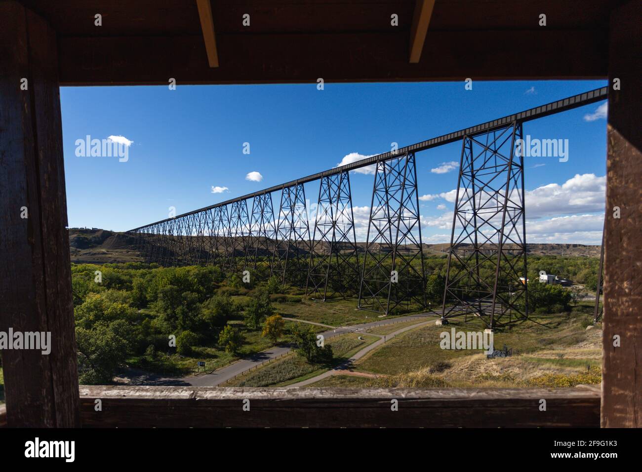 view of a super tall and long steel bridge in summer with blue sky from