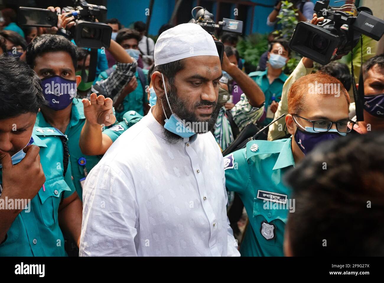 Dhaka, Bangladesh. 18th Apr, 2021. Police officers escort Mamunul Haque, a joint secretary of hardline Islamist group Hefazat-e-Islam, following his arrest in Dhaka.Joint teams of police and detectives raided Jamia Rahmania Arabia Madrasa in Dhaka today and apprehended the Hefazat leader, who has been in the limelight due to some recent controversies. (Photo by Sultan Mahmud Mukut/SOPA Images/Sipa USA) Credit: Sipa USA/Alamy Live News Stock Photo