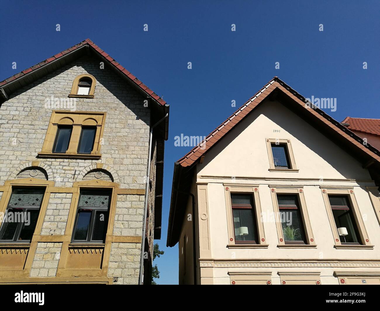 A low angle shot of modern houses under blue sky Stock Photo - Alamy