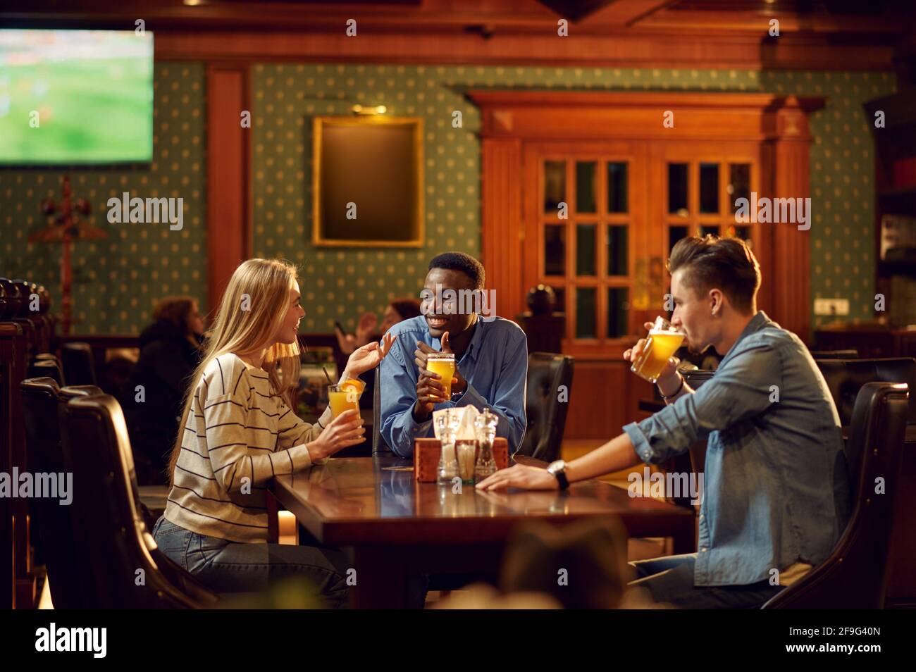 Football fans watching game translation in bar Stock Photo Alamy