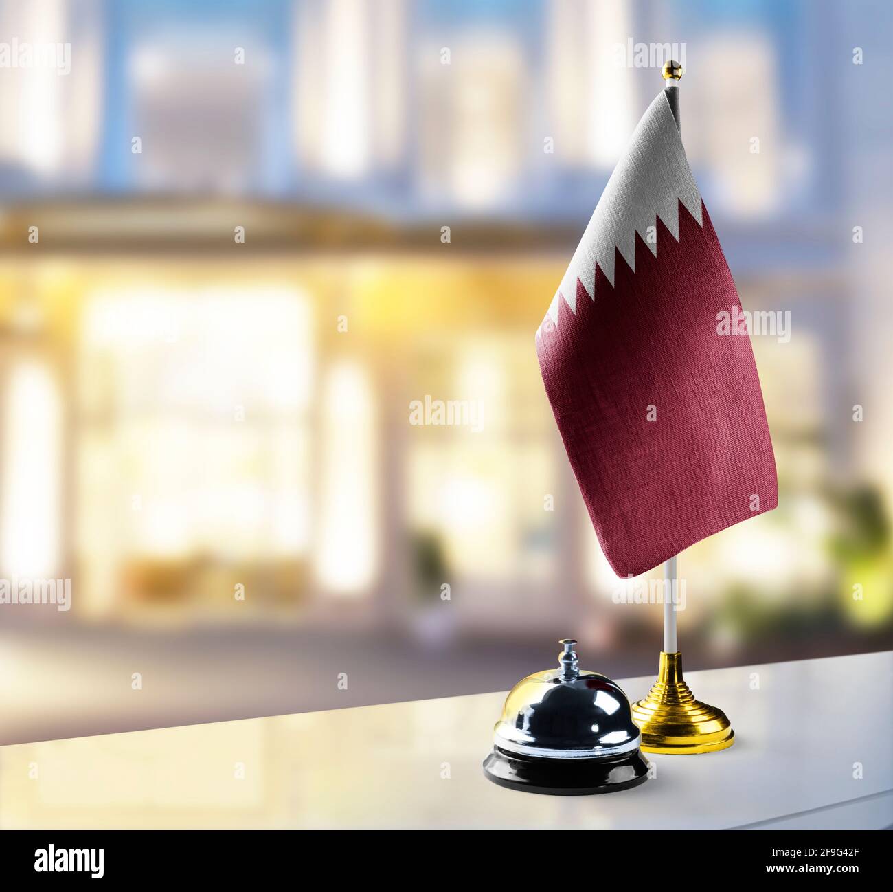 Qatar flag on the reception desk in the lobby of the hotel Stock Photo