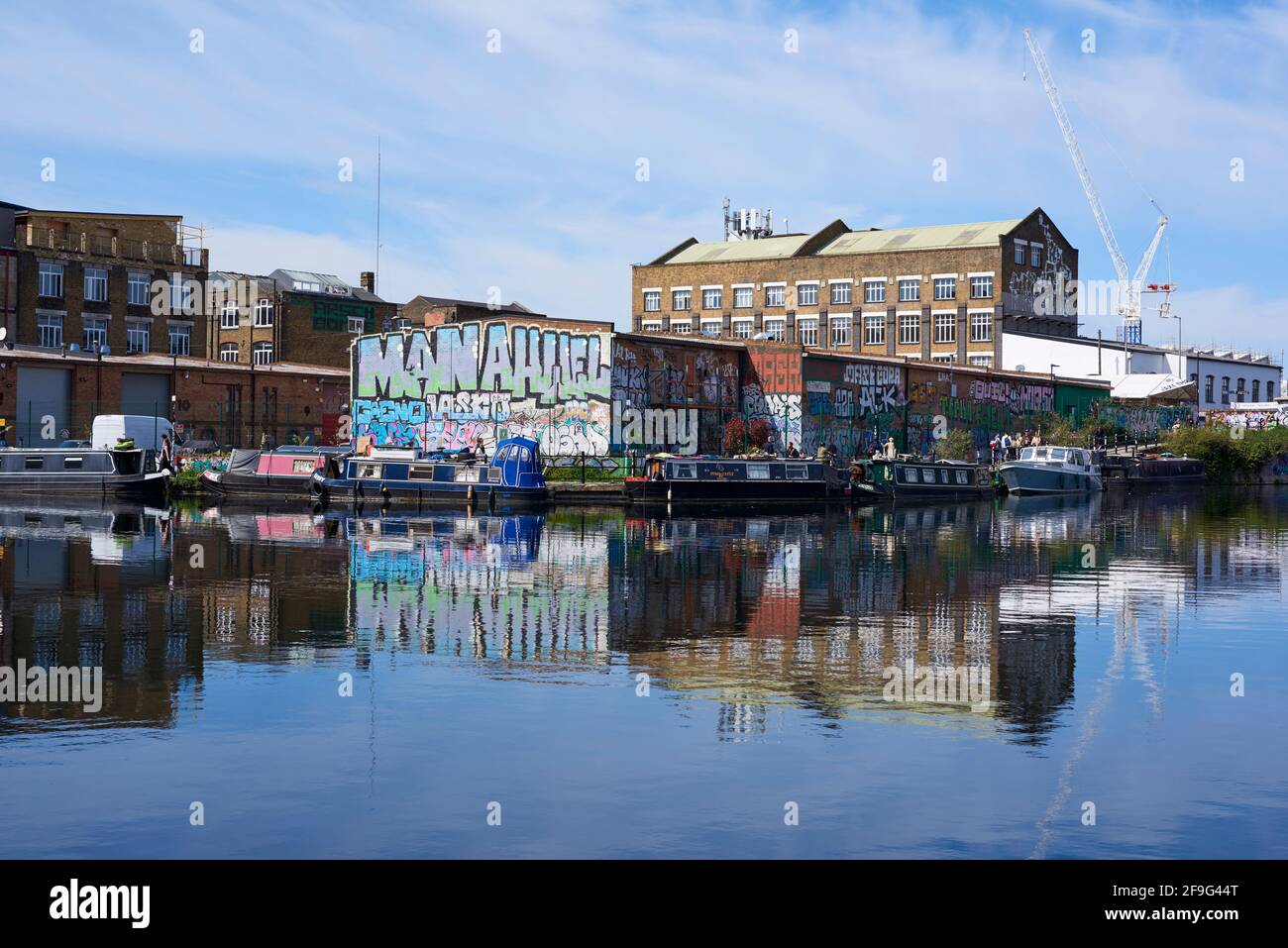 Narrowboats and buildings along the River Lea Navigation at Hackney Wick, East London UK Stock Photo